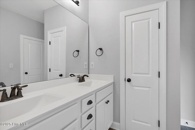 bathroom with a sink and double vanity
