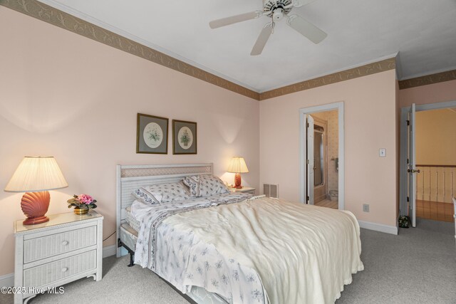 bedroom featuring visible vents, ceiling fan, baseboards, carpet, and ensuite bathroom