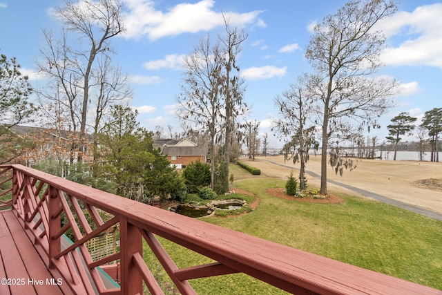deck featuring a lawn and driveway