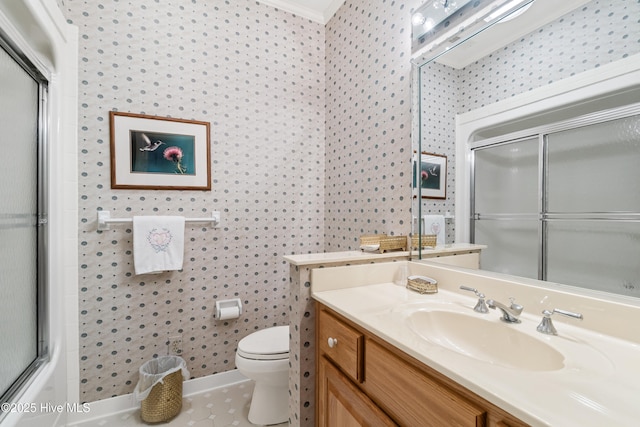 bathroom featuring tile patterned floors, toilet, vanity, and ornamental molding