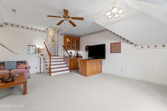 living room with visible vents, light carpet, stairway, baseboards, and ceiling fan