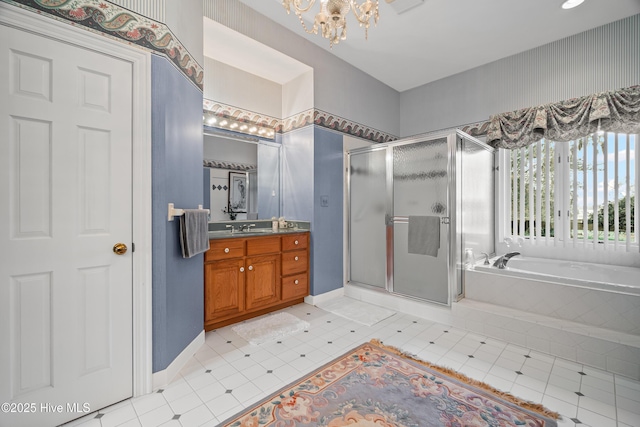 bathroom with a garden tub, a notable chandelier, a shower stall, baseboards, and vanity