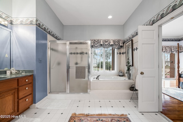 full bath with a bath, a shower stall, and vanity