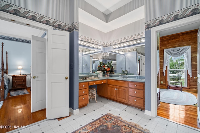 bathroom with vanity, an inviting chandelier, and baseboards