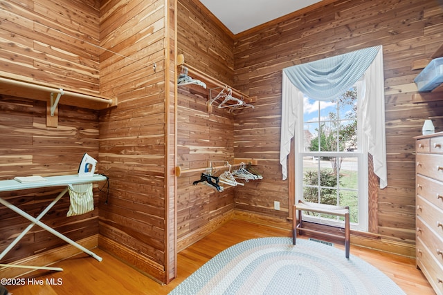 walk in closet with visible vents and wood finished floors