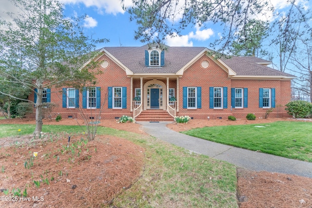 view of front of home featuring crawl space, a front lawn, brick siding, and roof with shingles