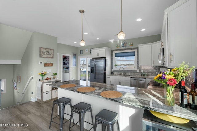 318 N Topsail Dr, Surf City, NC 28445 - kitchen featuring white cabinets, light stone counters, backsplash, and stainless steel appliances