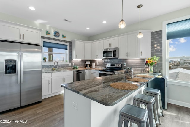 318 N Topsail Dr, Surf City, NC 28445 - dining area featuring visible vents, light wood-style flooring, and baseboards