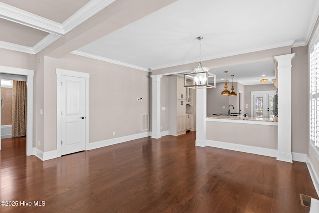 unfurnished dining area with visible vents, a notable chandelier, dark wood finished floors, and ornamental molding