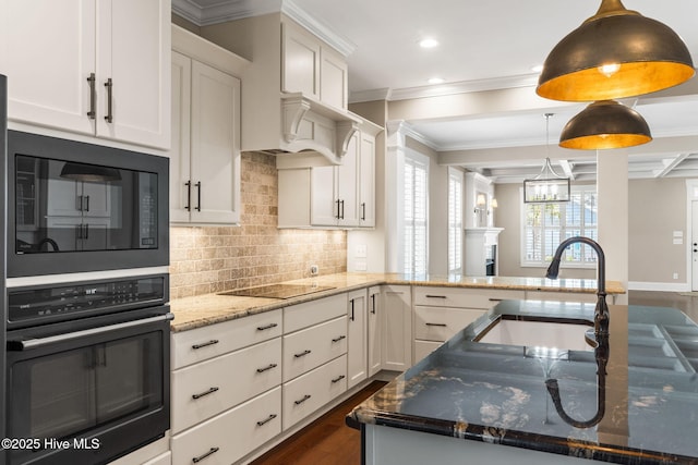 kitchen featuring tasteful backsplash, dark wood-style floors, white cabinets, black appliances, and a sink