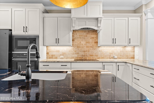 kitchen featuring tasteful backsplash, premium range hood, freestanding refrigerator, and ornamental molding