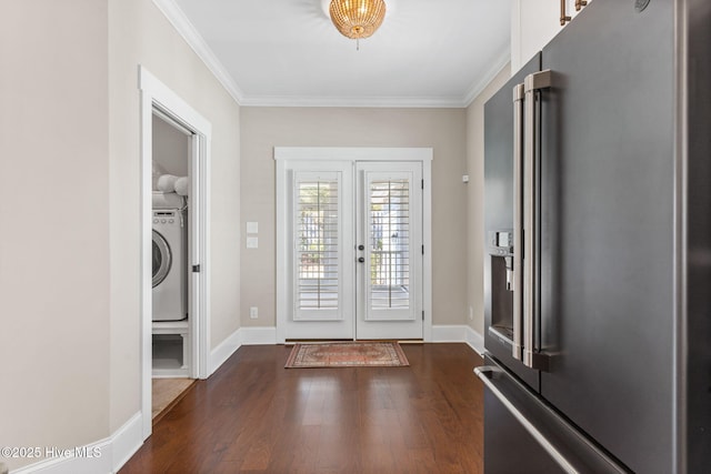 foyer with dark wood finished floors, washer / dryer, crown molding, and baseboards