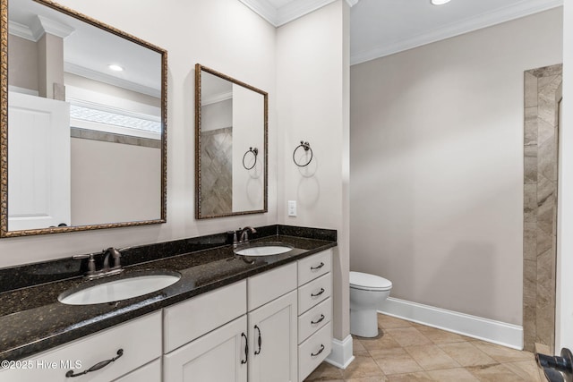 bathroom featuring crown molding, toilet, and a sink