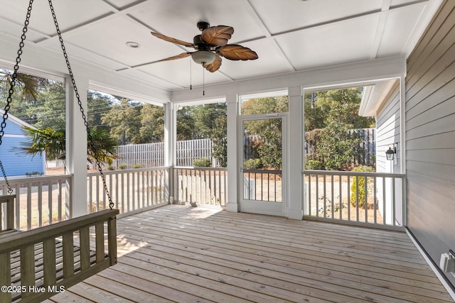 unfurnished sunroom with plenty of natural light, a ceiling fan, and coffered ceiling