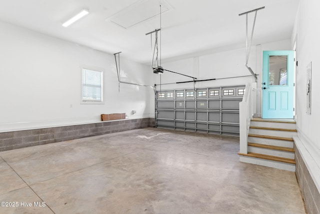 garage with electric panel and a garage door opener