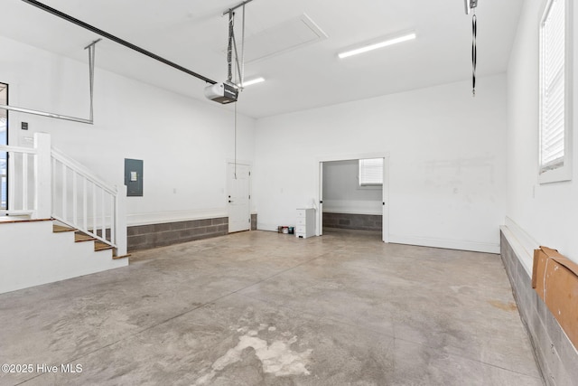 garage featuring electric panel and a garage door opener