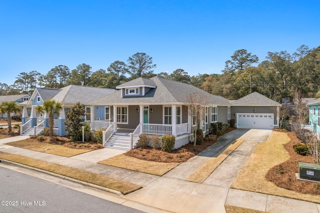 view of front facade with a garage, covered porch, and driveway