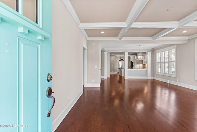 entryway with coffered ceiling, dark wood finished floors, ornamental molding, and ornate columns