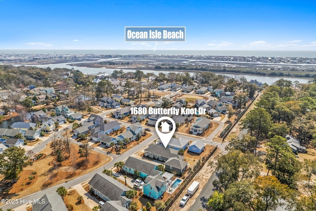 birds eye view of property featuring a water view and a residential view