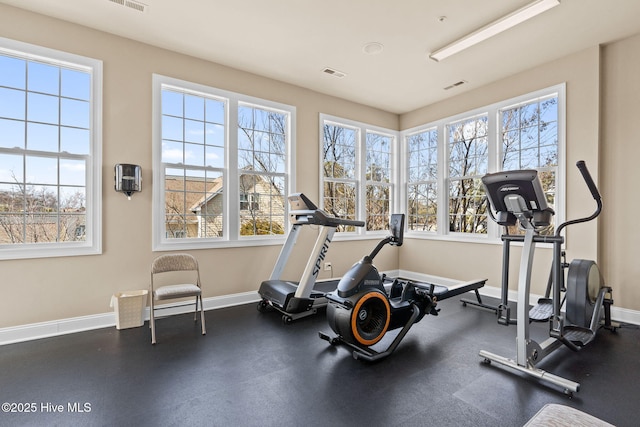 workout area featuring plenty of natural light, baseboards, and visible vents