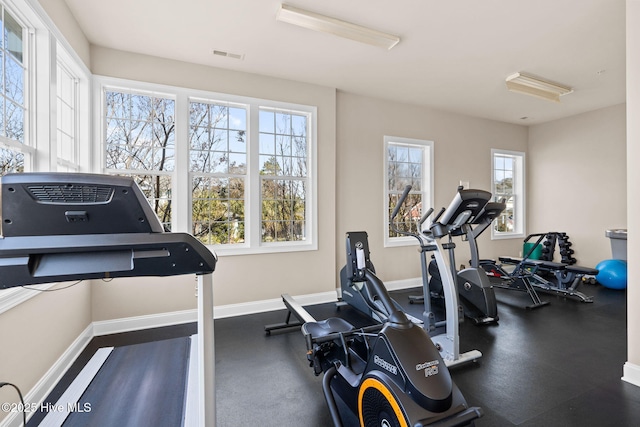 workout room with baseboards and visible vents