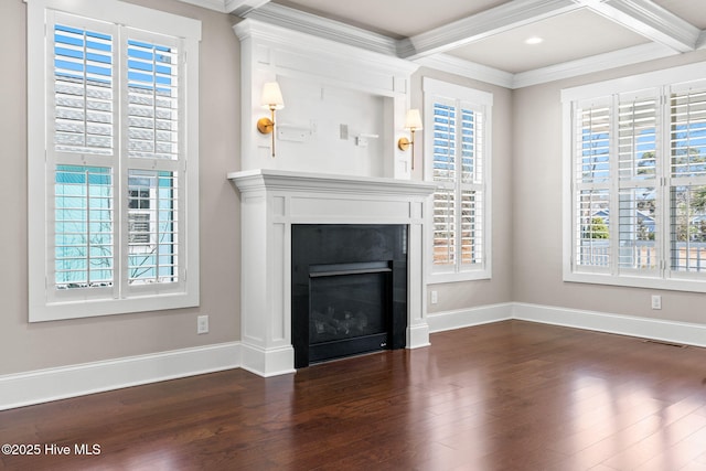 unfurnished living room with a wealth of natural light, dark wood-style floors, and crown molding