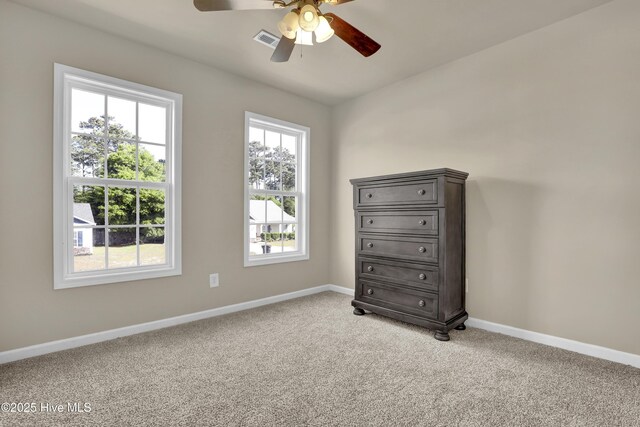 bedroom featuring baseboards, light carpet, a ceiling fan, and visible vents