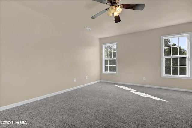 carpeted spare room with a ceiling fan, baseboards, and visible vents