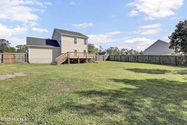 view of yard with a fenced backyard, a deck, and stairway