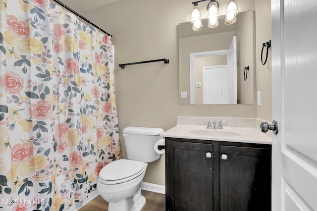bathroom with wood finished floors, vanity, baseboards, toilet, and a shower with shower curtain