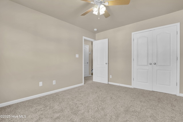 unfurnished bedroom with a closet, baseboards, and carpet flooring