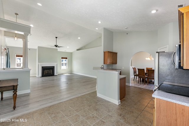 208 Carolina Beach Ave S # 300, Carolina Beach, NC 28428 - kitchen featuring a ceiling fan, light countertops, recessed lighting, a fireplace, and light tile patterned floors