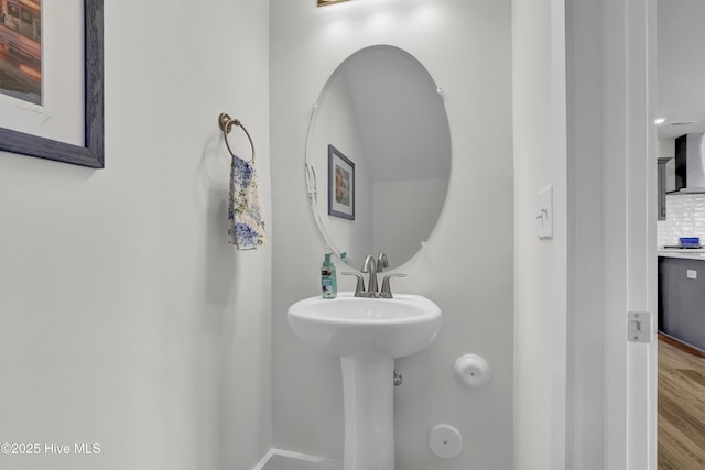 410 Sugar Cv, Wilmington, NC 28411 - bathroom with wood finished floors and backsplash