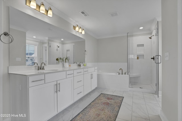 410 Sugar Cv, Wilmington, NC 28411 - full bathroom featuring marble look tile flooring, a garden tub, double vanity, a stall shower, and recessed lighting