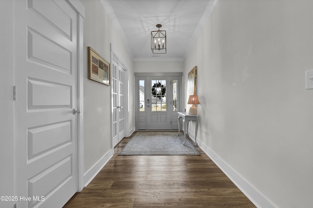 410 Sugar Cv, Wilmington, NC 28411 - foyer with a chandelier, dark wood-style floors, and crown molding
