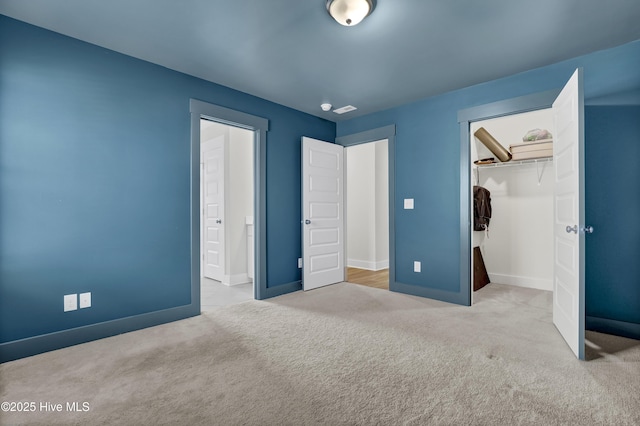 410 Sugar Cv, Wilmington, NC 28411 - unfurnished bedroom with carpet, a closet, and a walk in closet