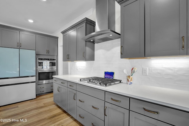 410 Sugar Cv, Wilmington, NC 28411 - kitchen with wall chimney exhaust hood, appliances with stainless steel finishes, gray cabinets, and recessed lighting