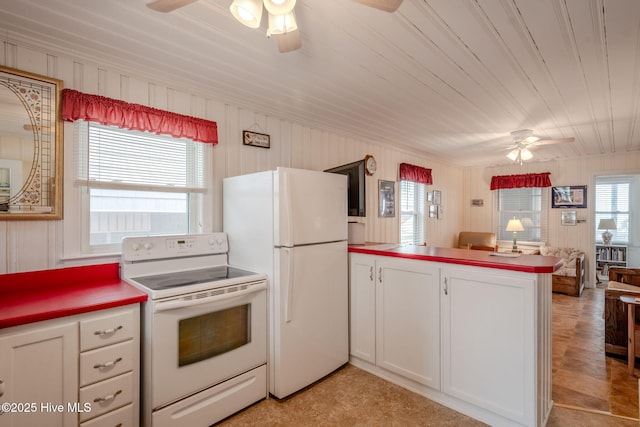107 Carolina Beach Ave S, Carolina Beach, NC 28428 - kitchen featuring open floor plan, white appliances, ceiling fan, a peninsula, and white cabinetry