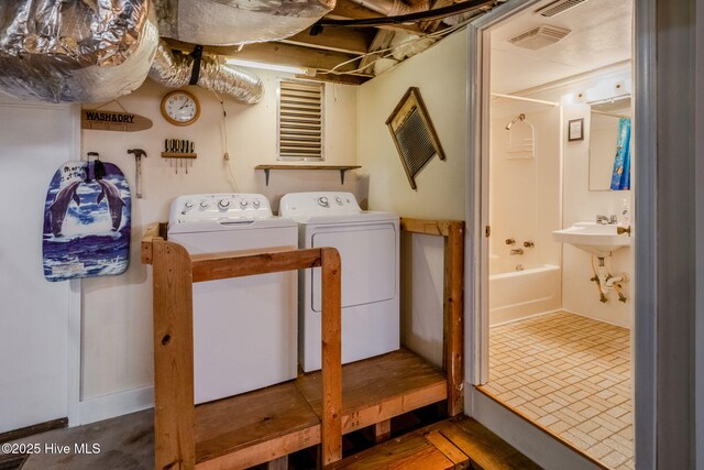 107 Carolina Beach Ave S, Carolina Beach, NC 28428 - clothes washing area with washing machine and dryer, visible vents, and laundry area