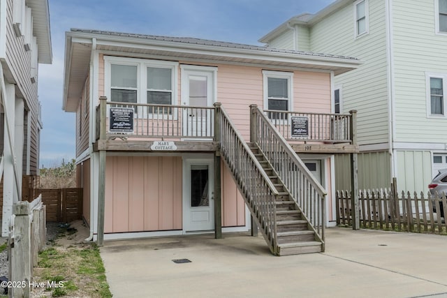 107 Carolina Beach Ave S, Carolina Beach, NC 28428 - back of property featuring fence, a patio area, board and batten siding, and stairway
