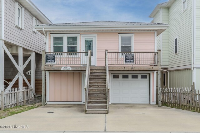 107 Carolina Beach Ave S, Carolina Beach, NC 28428 - view of front of home with driveway, fence, stairway, and a garage