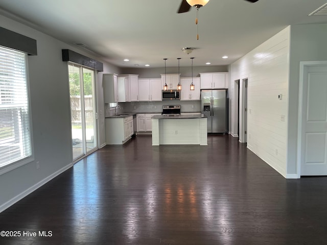 kitchen with dark wood-style flooring, ceiling fan, appliances with stainless steel finishes, and visible vents
