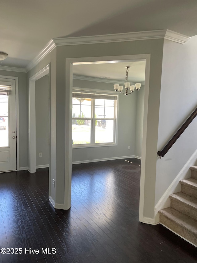 entrance foyer with baseboards, dark wood finished floors, crown molding, and stairway