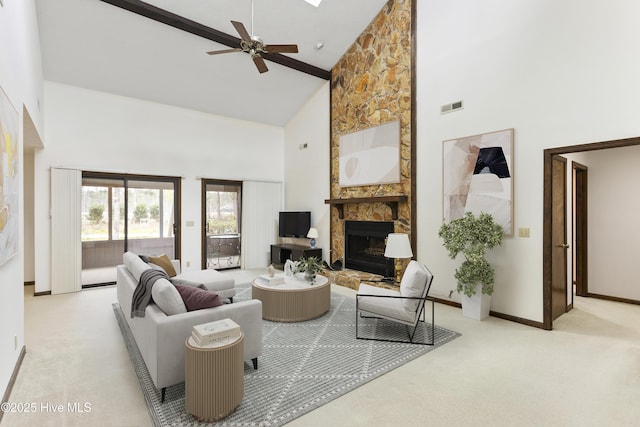 carpeted living room with a fireplace, high vaulted ceiling, a ceiling fan, baseboards, and visible vents