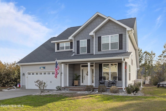 1203 Strange Ct, Morehead City, NC 28557 - view of front of home featuring a porch, an attached garage, concrete driveway, a front yard, and a shingled roof