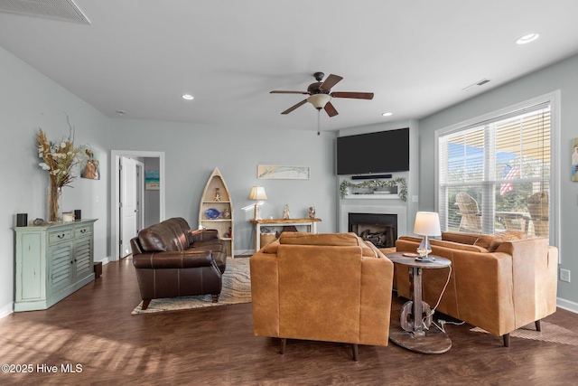 1203 Strange Ct, Morehead City, NC 28557 - living room featuring a fireplace, ceiling fan, dark wood-style floors, baseboards, and recessed lighting