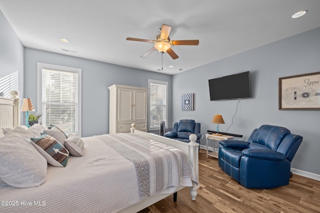 1203 Strange Ct, Morehead City, NC 28557 - bedroom featuring wood finished floors, multiple windows, baseboards, a ceiling fan, and recessed lighting