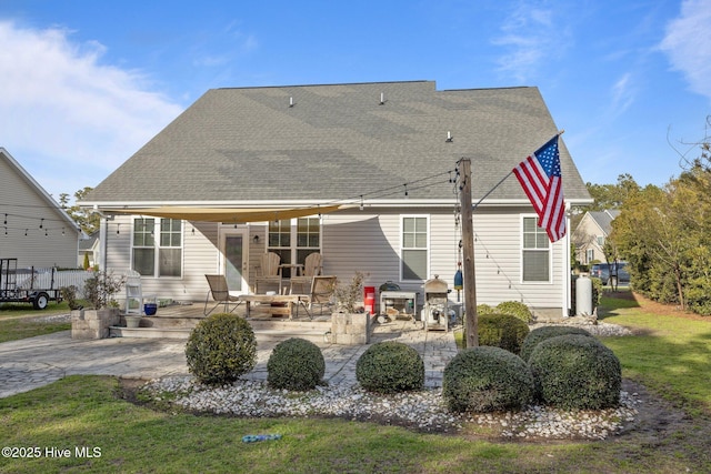 1203 Strange Ct, Morehead City, NC 28557 - rear view of property featuring a patio area, a shingled roof, and a lawn