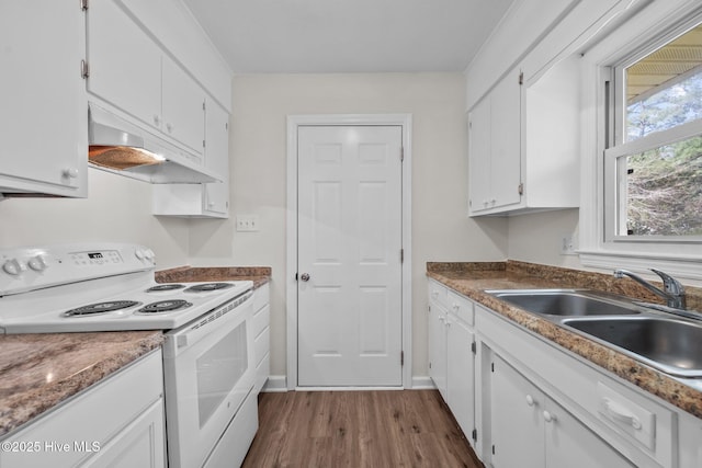 kitchen with white electric range oven, dark wood finished floors, a sink, white cabinets, and under cabinet range hood