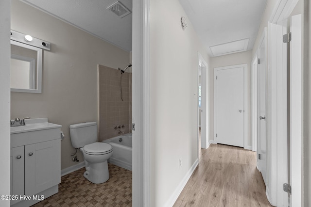 bathroom featuring vanity, toilet, baseboards, and visible vents